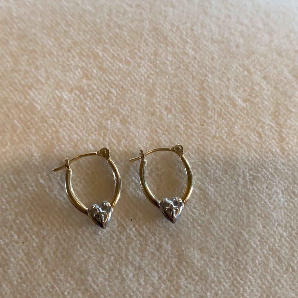 Small gold hoop earrings with silver heart and cross